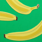 Three bananas on a green background