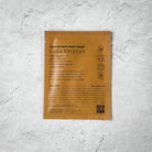Korean face sheet mask packaging with text on a textured gray background