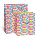 Two gift bags with rainbow and cloud pattern on a white background