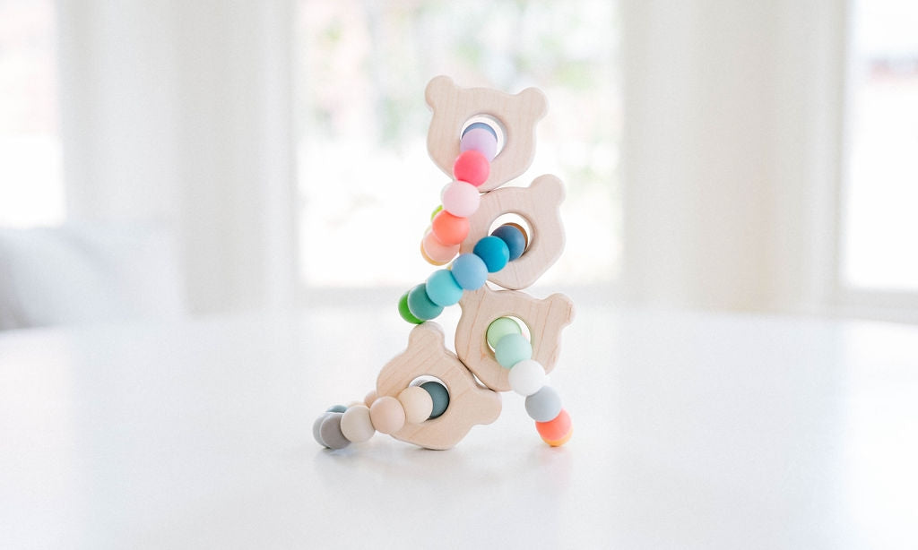 Mini Bear Wooden & Silicone Teether by Bannor Toys featuring a smooth, natural maple wood bear-shaped ring paired with colorful, chewable silicone beads.