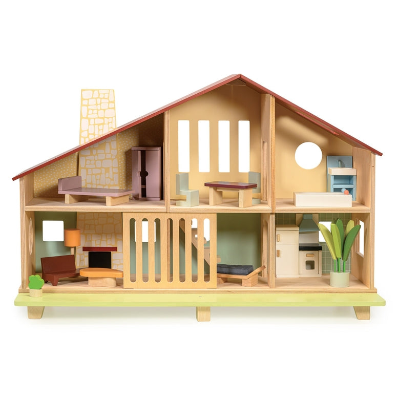 Wooden Cedar Chalet Modernist Dollhouse by Mentari featuring a mid-century modern architectural design with an open-front layout, a red gabled roof, a pebble-dash style chimney breast, and six furnished rooms complete with a starter set of modernist furniture and a sliding ground-floor grill opening onto an urban lawn with a potted plant and bench.