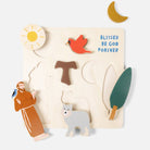 Wooden puzzle with religious figures, animals, and nature elements on a white background.