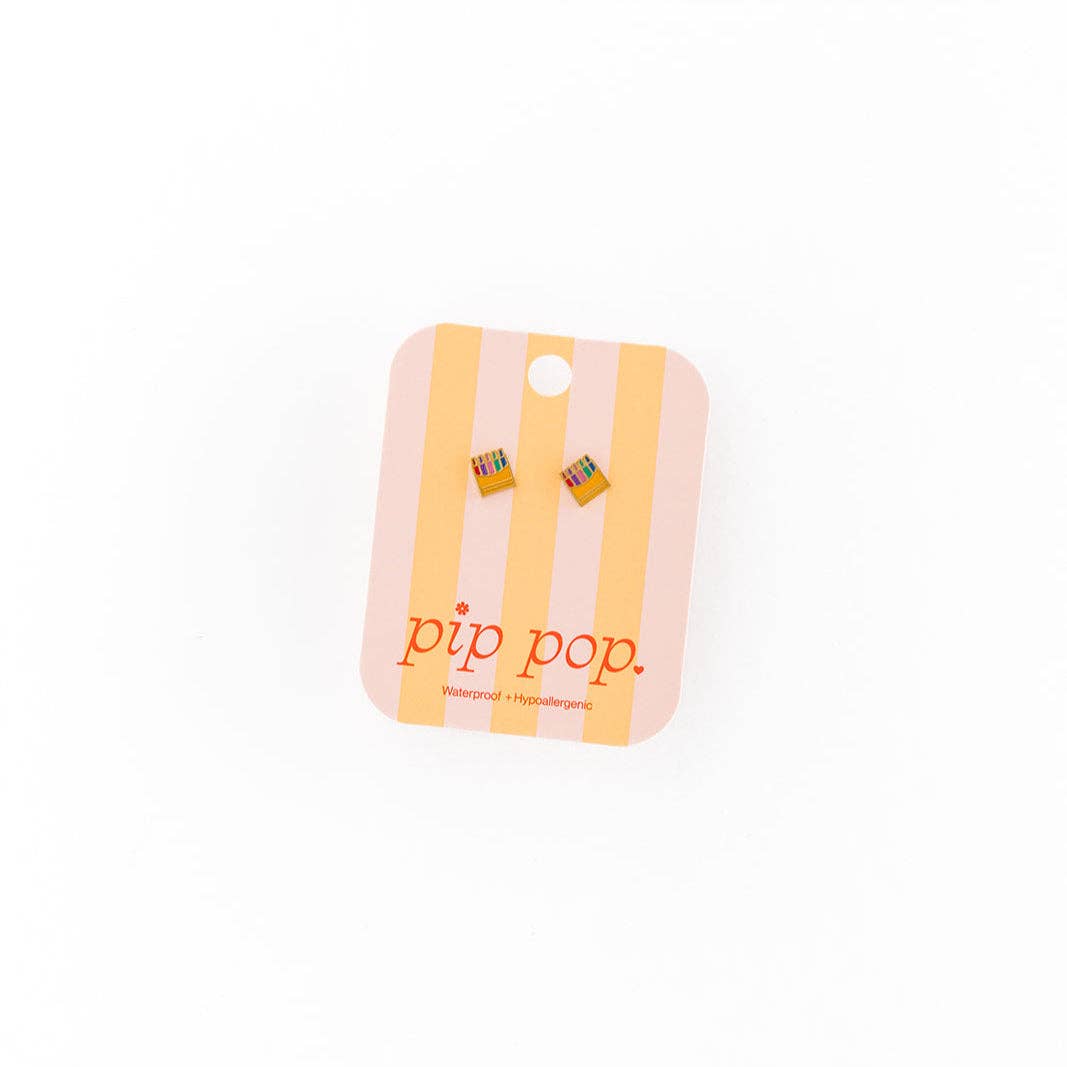 Pair of earrings on a 'pip pop.' branded card against a white background