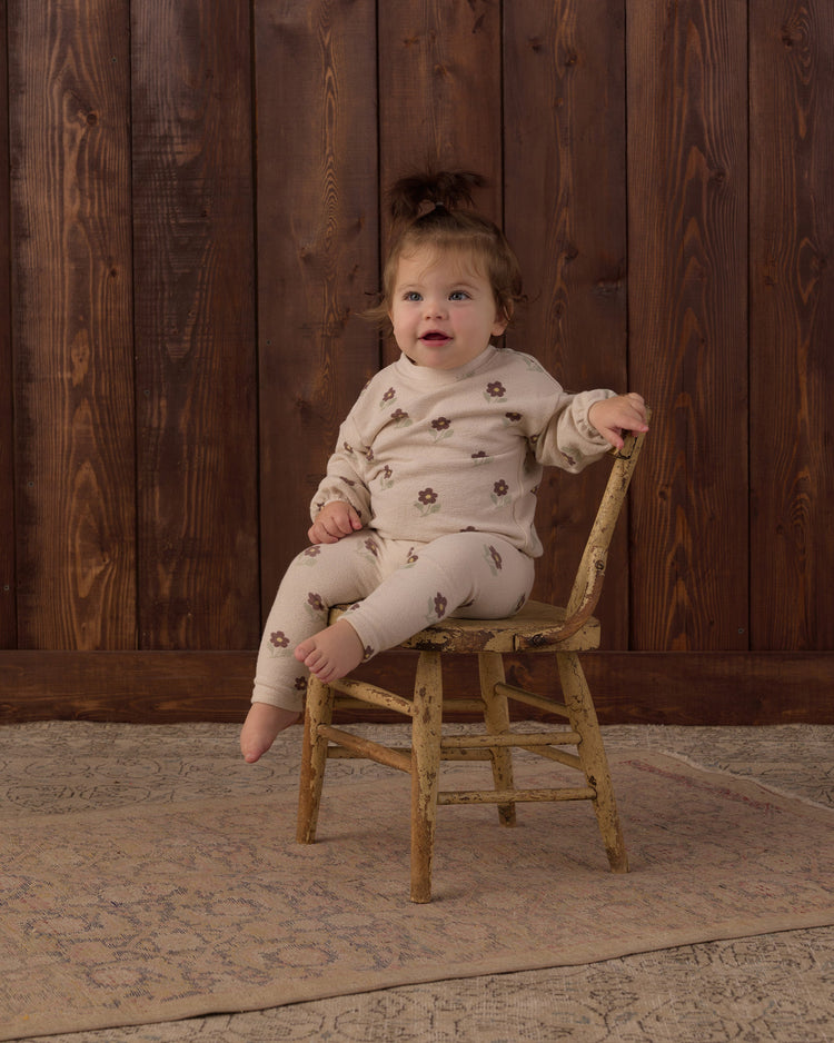 A toddler wearing the Rylee + Cru Spongey Knit Set in Petal Daisy featuring an all-over tiny floral print on soft beige knit fabric.