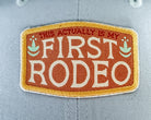 'First Rodeo' logo on a patterned surface