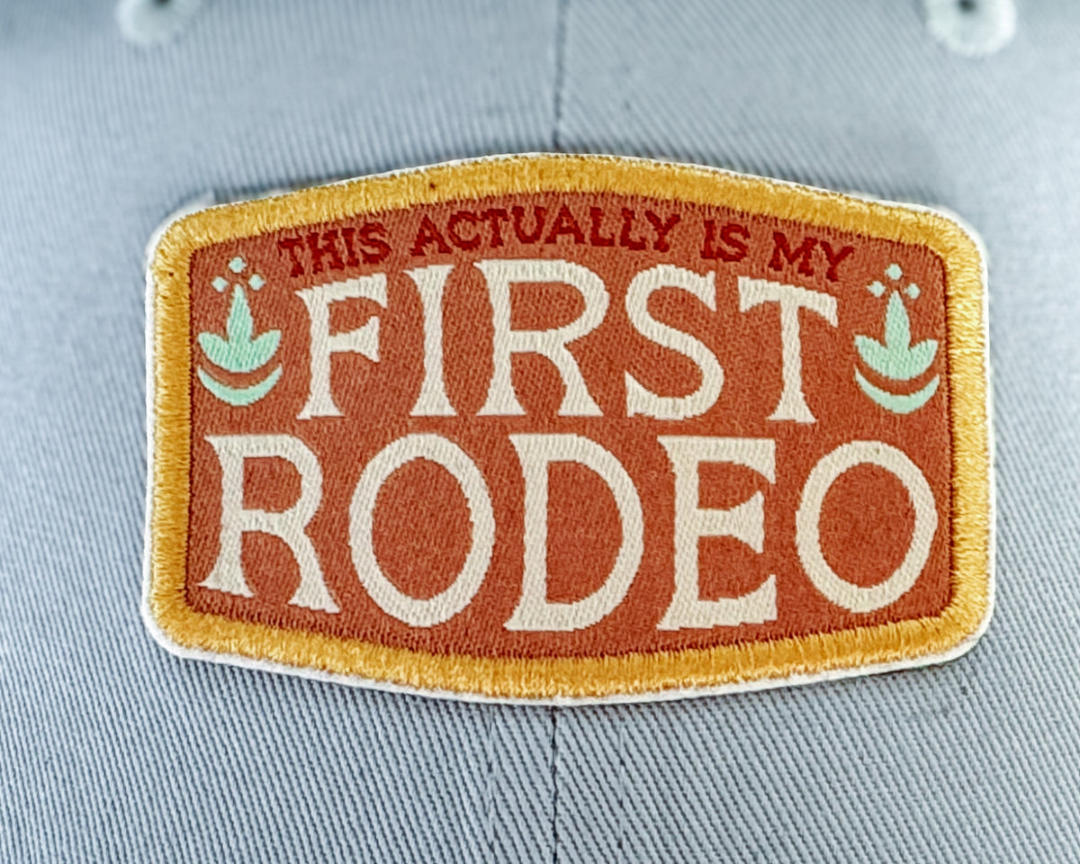 'First Rodeo' logo on a patterned surface