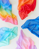 Colorful fabric swatches arranged in a circular pattern on a white background