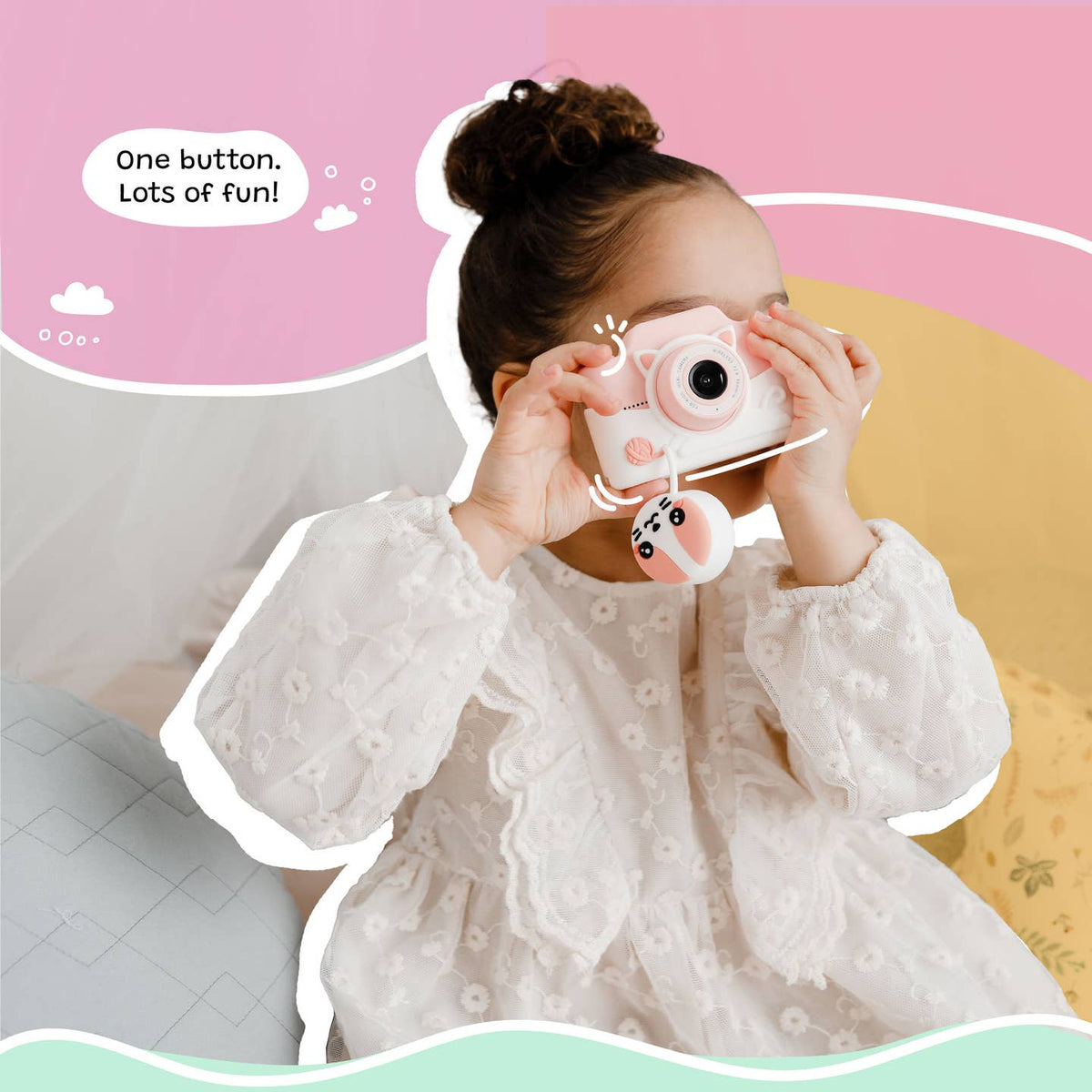 Child holding a pink toy camera with a colorful background