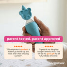 A hand holds a light blue Oogiebear aspirator with a bear-shaped tip against a softly blurred indoor background. Prominent text overlays read 'parent tested, parent approved' with two customer review cards below.