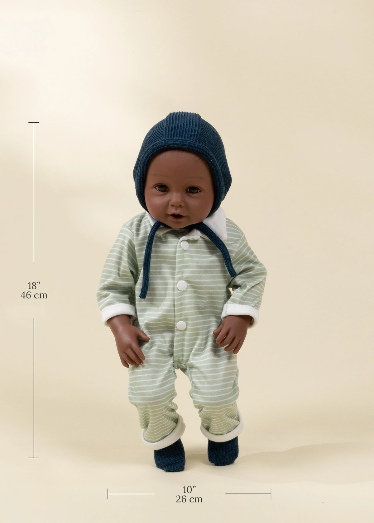 Baby in a striped outfit and blue hat with measurements on a beige background