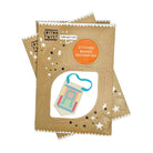 Three stacked cotton twist craft kits for making stitched banner decorations, featuring brown kraft paper packaging with white star and geometric designs and an orange circular label.