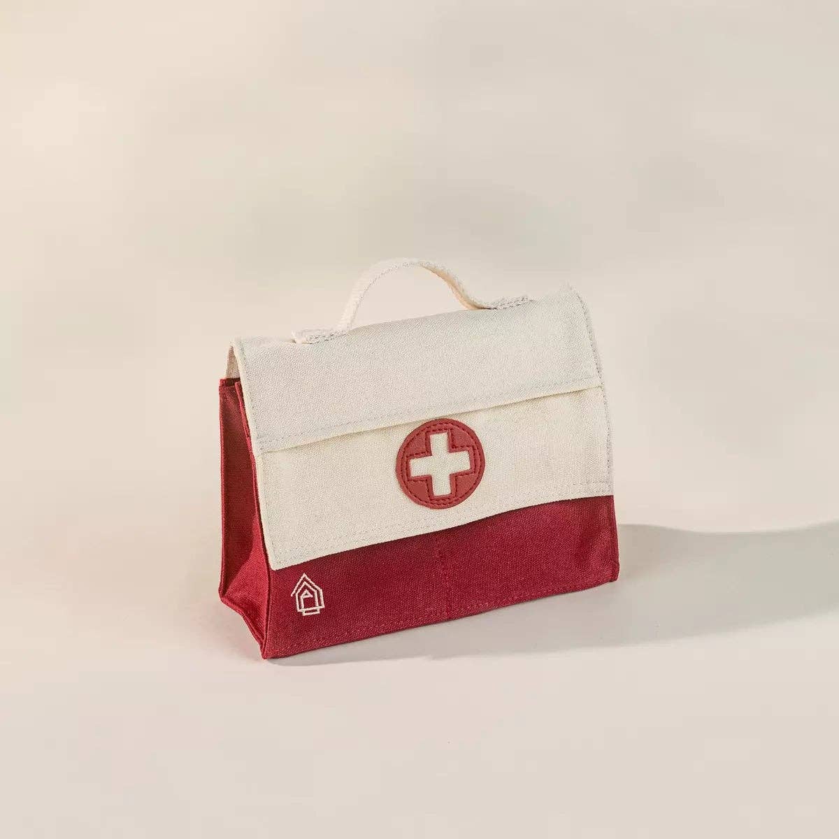 Red and cream fabric bag on a white background.