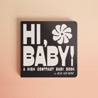 Black book titled 'Hi, Baby!' with white text and a flower illustration on a beige background