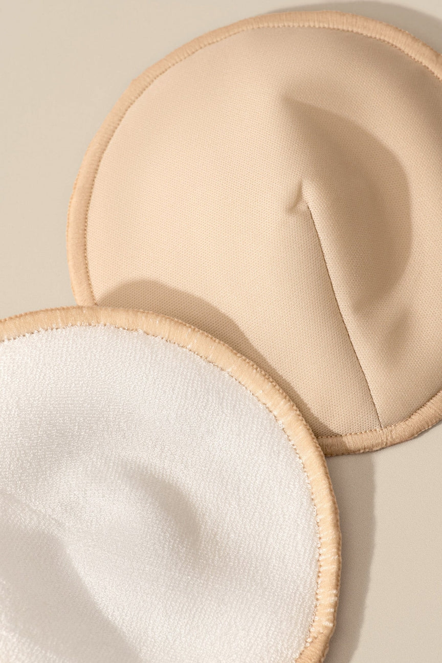 Two beige and white pads on a light beige background
