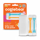 Oogie Bear baby nose and ear picker set with its retail packaging. The set includes two bear-shaped picks in orange and light blue, shown both inside their clear plastic case and standing next to the orange branded cardboard box.