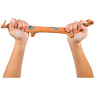 Two hands holding a wooden stick with blue markings against a white background