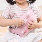 Child holding a pink backpack with cartoon design