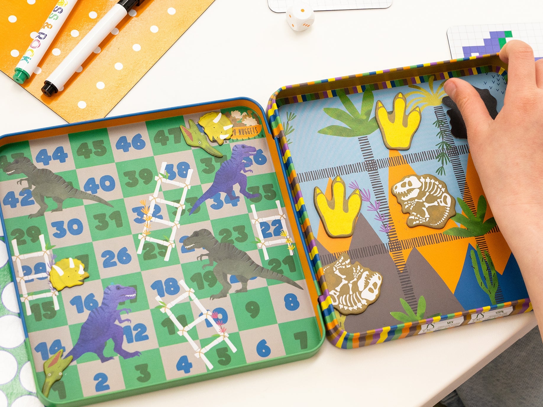 Colorful children's game with dinosaur design on a white surface
