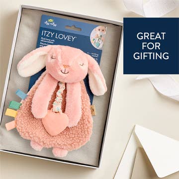 Pink plush bunny toy with packaging labeled 'Itzy Lovey' in a box, with text 'Great for Gifting'.