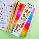 Colorful sticker book with various stickers on a green background