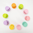 Colorful hair clips arranged on a white background