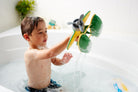 Child playing with a toy airplane in a bathtub