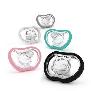 Five baby pacifiers in different colors on a white background