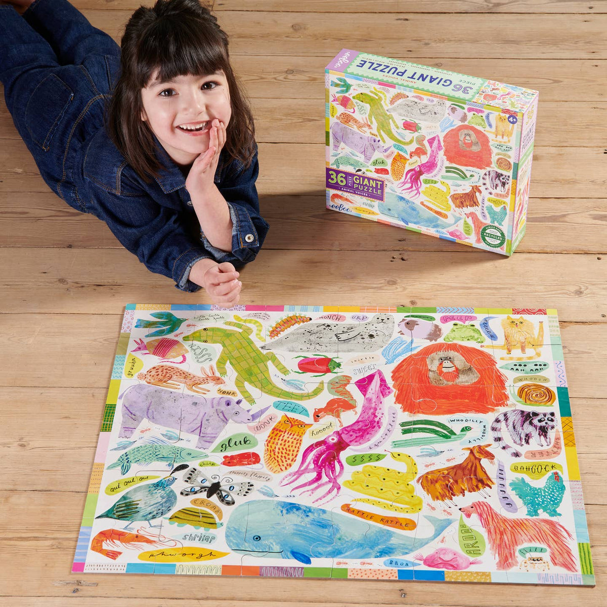 Child with a partially completed animal-themed puzzle on a wooden floor