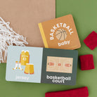 Two children's books on a green surface with basketball-themed illustrations and text.
