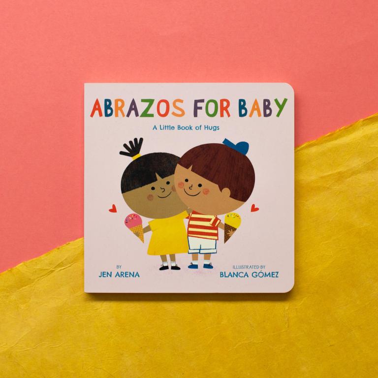 Children's book titled 'Abrazos for Baby' with colorful illustrations on a pink and yellow background