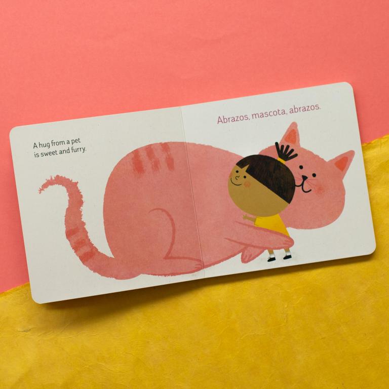 Illustrated book page with a child hugging a pink cat on a yellow and pink background