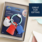 Baby teething ring set with colorful animals on packaging, displayed in a box.