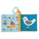 Children's soft book with colorful illustrations of a seagull and boats on a blue background.