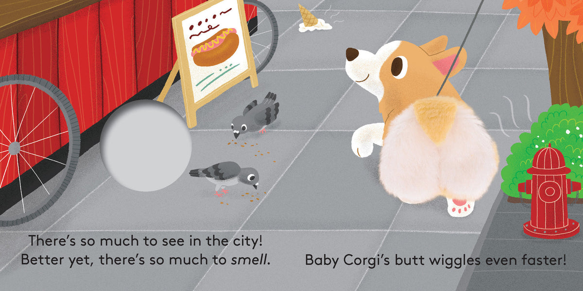 An illustrated page from "Baby Corgi Butt" featuring a corgi puppy walking past a red fire hydrant and pigeons on a city sidewalk, with a hot dog stand in the background, and text that reads "There's so much to see in the city! Better yet, there's so much to smell. Baby Corgi's butt wiggles even faster!"