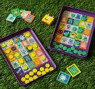 Colorful educational game with character buttons on a grassy background