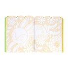 Open book with floral and animal illustrations on a white background