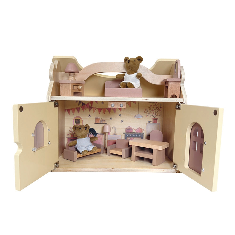 Wooden dollhouse with furniture and teddy bears on a white background