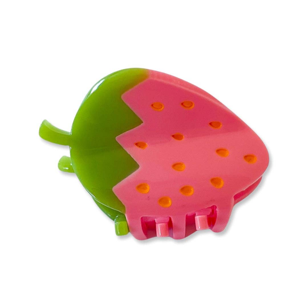 Strawberry-shaped pink and green plastic item on a white background