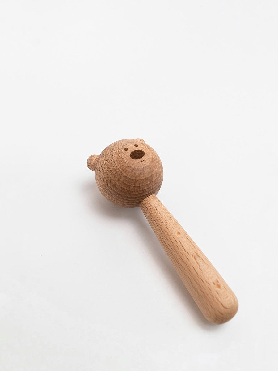 Wooden toy hammer with bear head on a white background