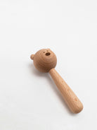 Wooden toy hammer with bear head on a white background