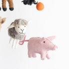 Plush toy animals including a sheep and a pig on a white background