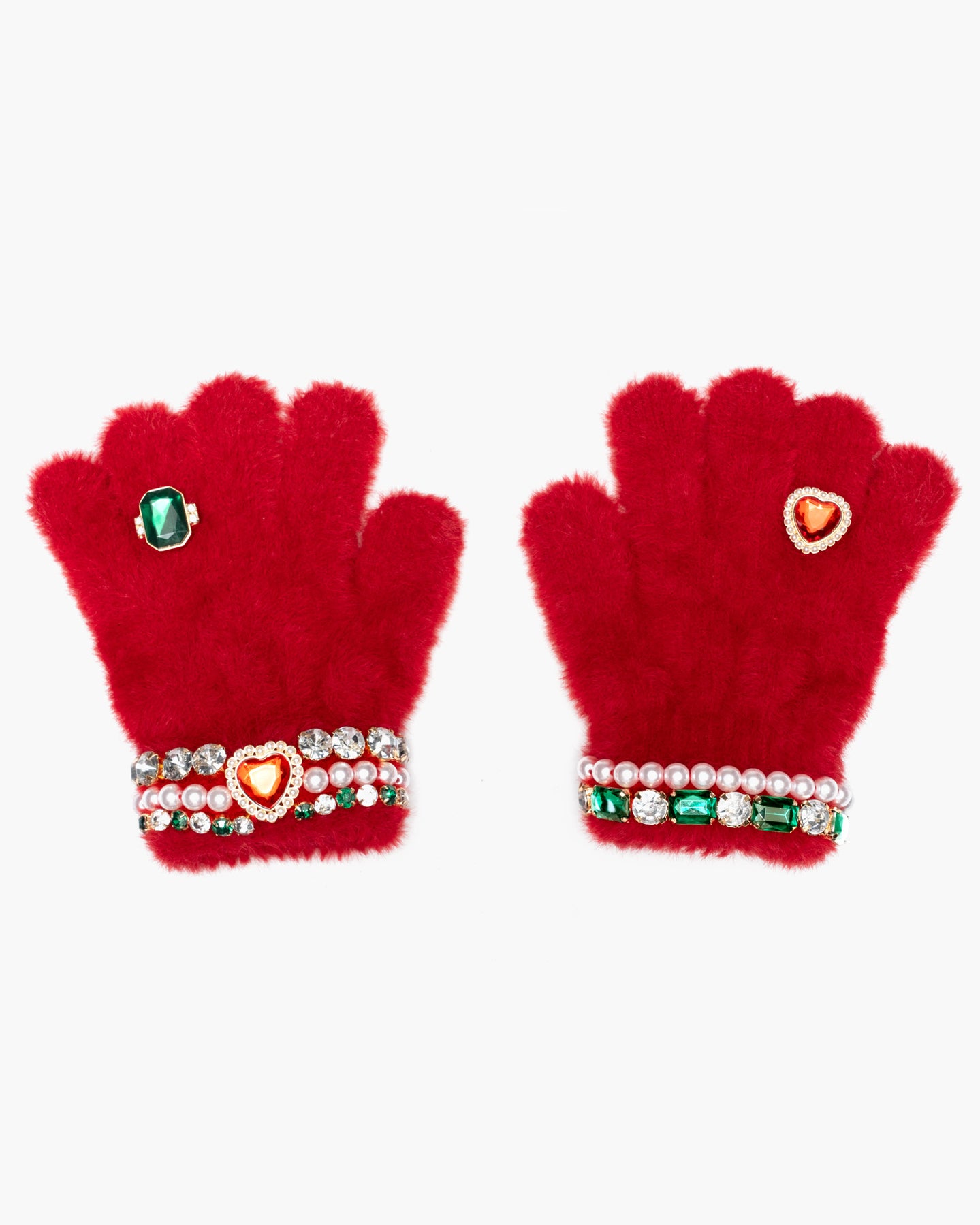 A pair of bright red fuzzy gloves decorated with rhinestone wristbands, a green oval gem, and a heart-shaped crystal accent on a plain white background.