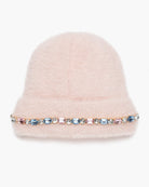 A light pink fuzzy beanie hat featuring a decorative band of colorful rhinestones, set against a plain white background.