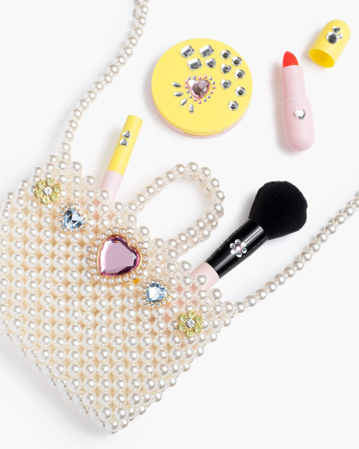 Makeup items with decorative elements on a white background