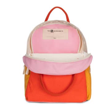 Colorful backpack with pink and orange sections on a white background