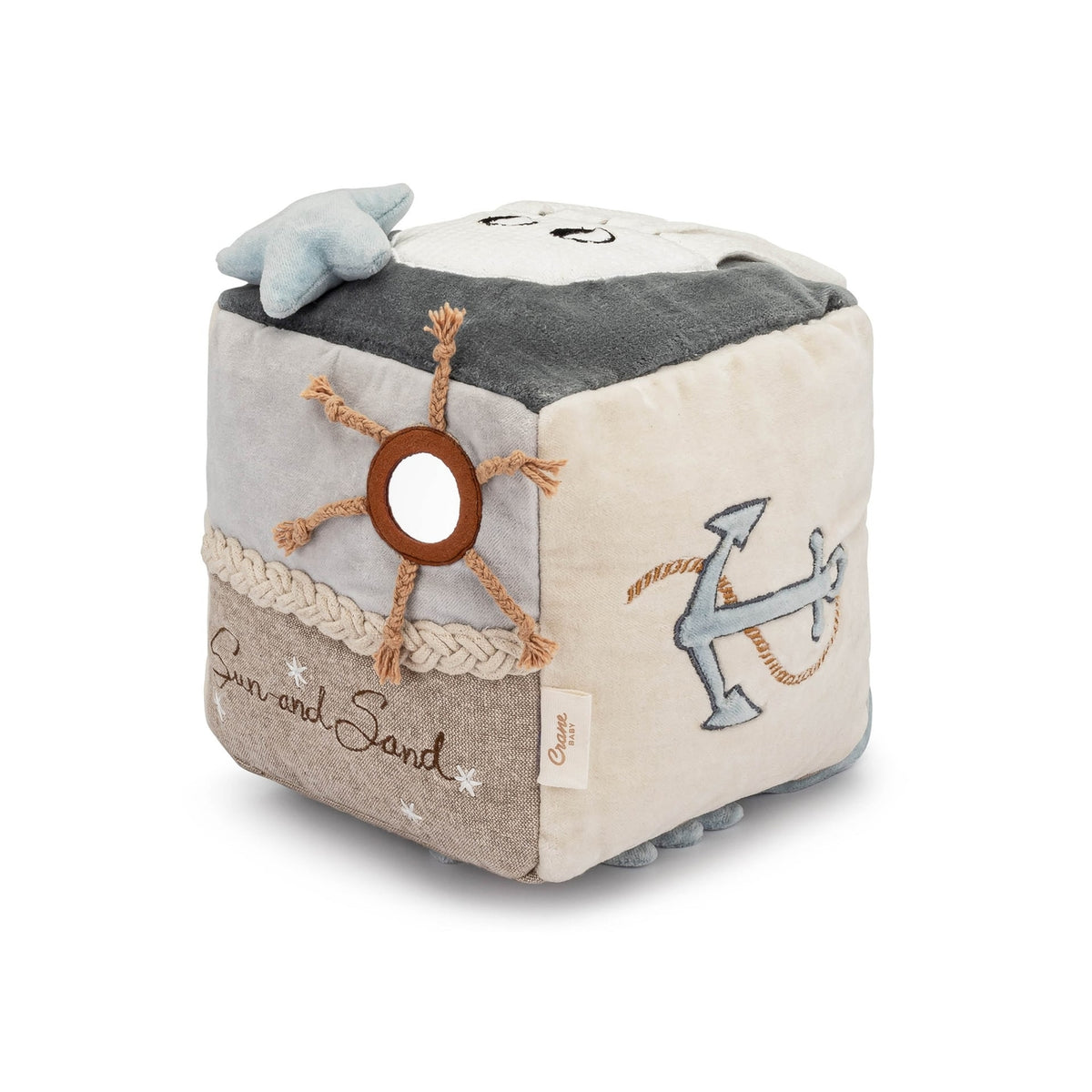 Children's soft cube toy with nautical designs on a white background