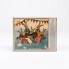 A square decorative box featuring an illustration of rabbits celebrating at a birthday party, with bunting, balloons, and the text 'HAPPY BIRTHDAY' on the front. The side panel contains small printed text, and the box is photographed against a clean white background.