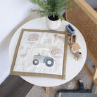 Children's play mat with farm-themed design on a round white table.