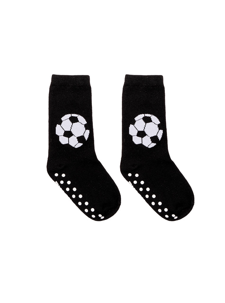 Black socks with soccer ball design and non-slip dots on a white background