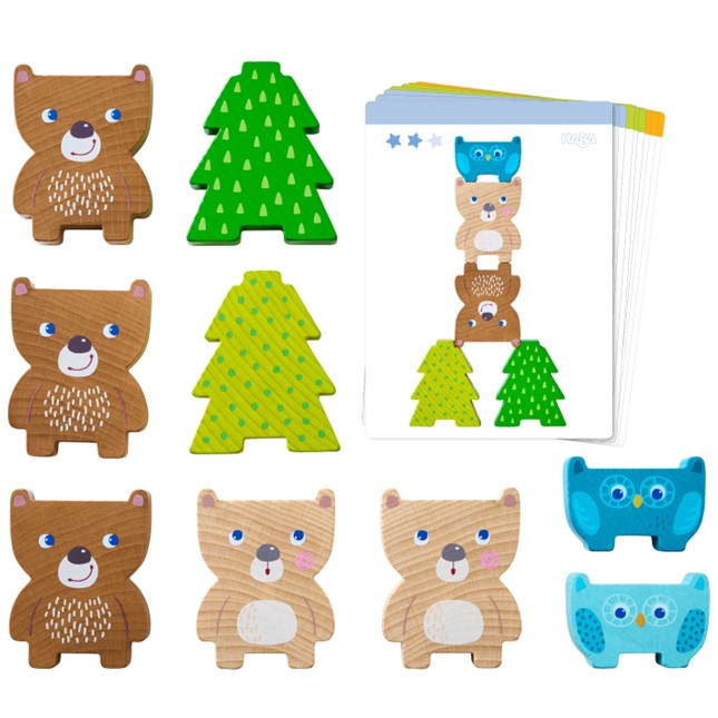 Set of wooden animal toys including bears, trees, and an owl on a white background